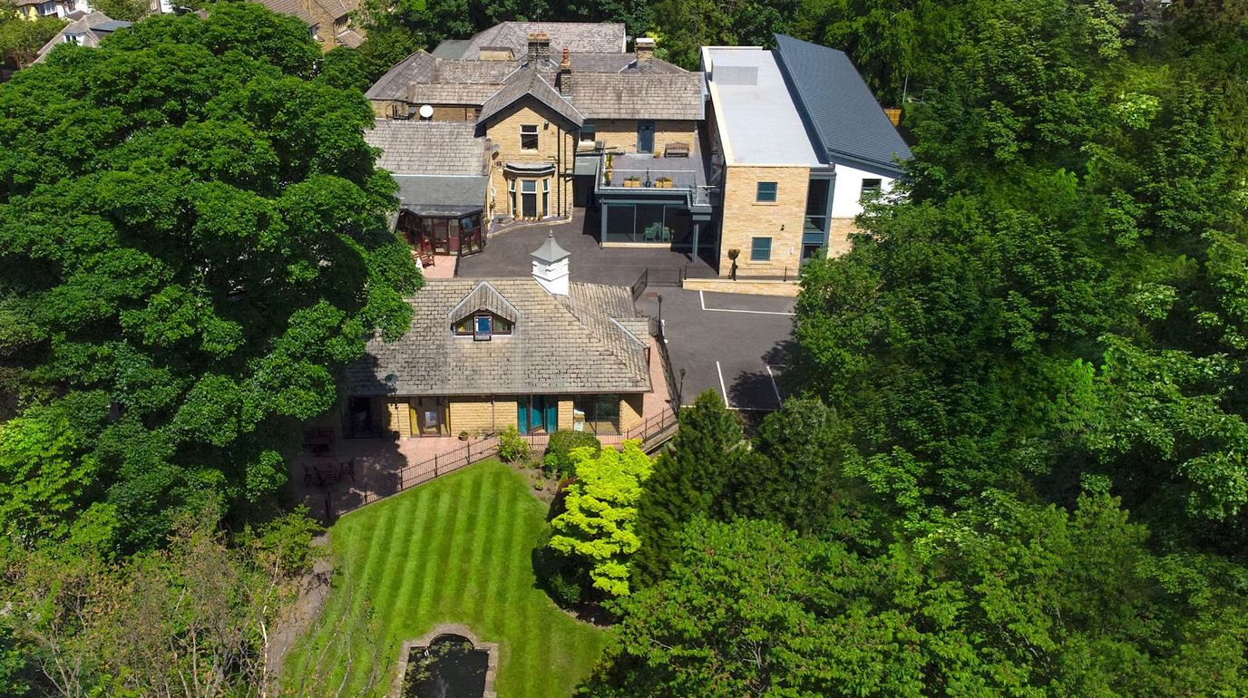 Aerial view of Well Springs Nursing Home surrounded by greenery