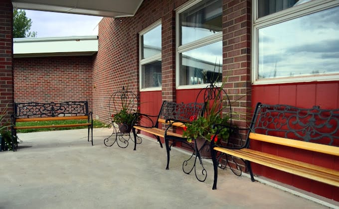 Outdoor seating area with benches and plants