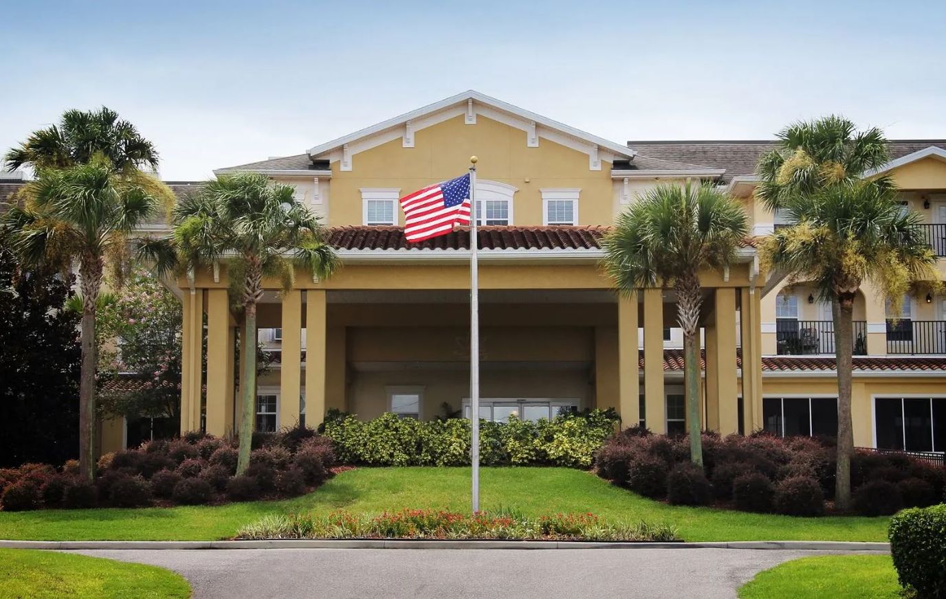 Front exterior view of a nursing home with American flag