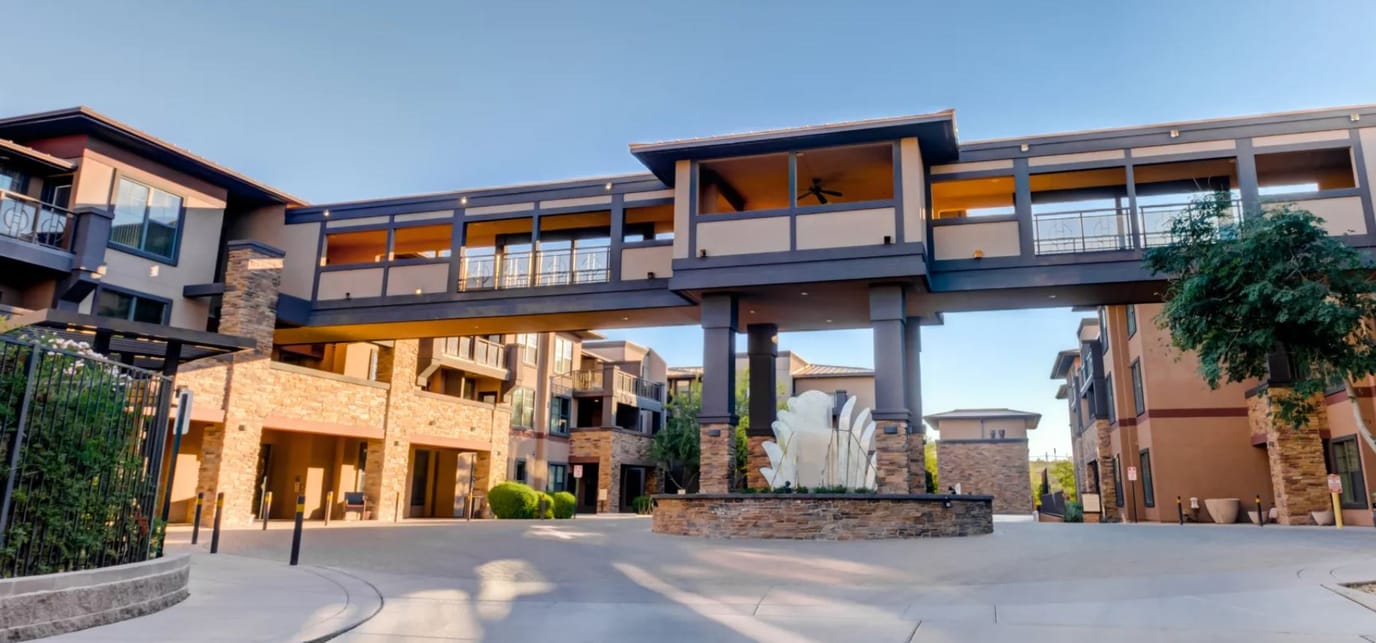 Exterior view of Andara Senior Living with a fountain