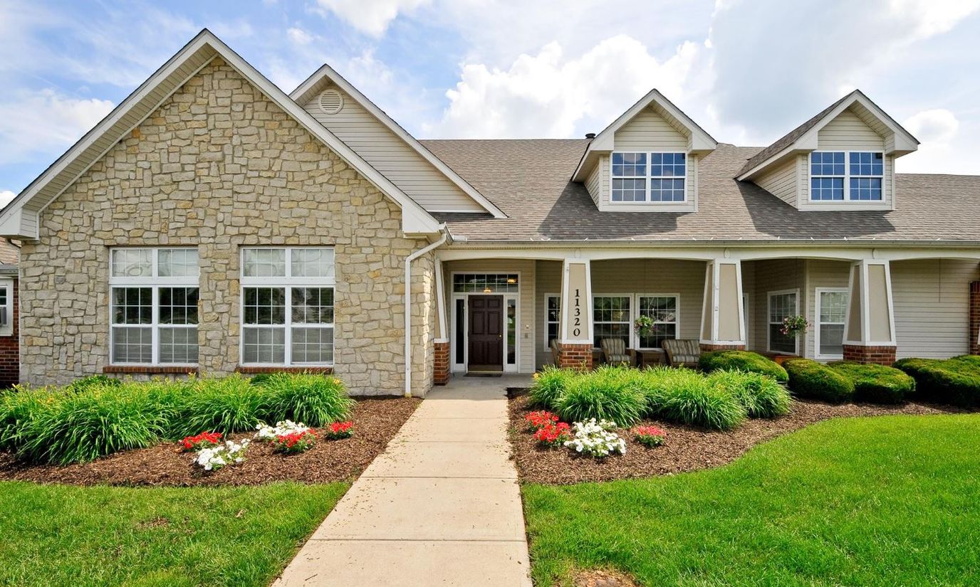 Exterior view of Brookdale Springdale with flowers and lawn