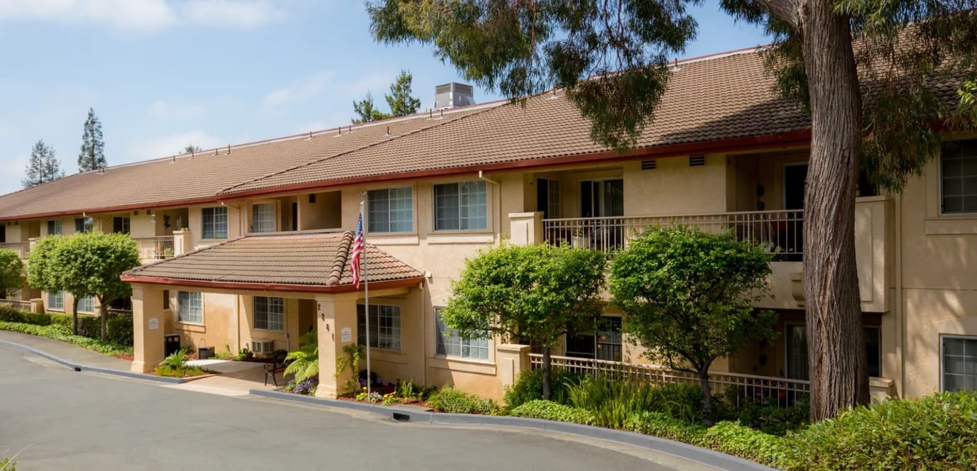 Exterior view of a senior living facility with landscaping