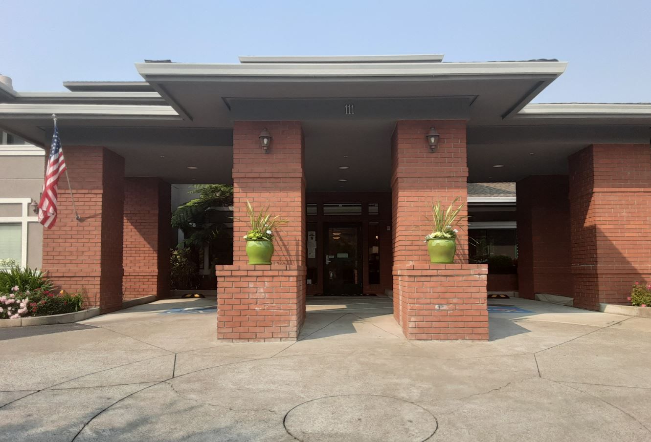 Exterior view of the facility entrance with greenery