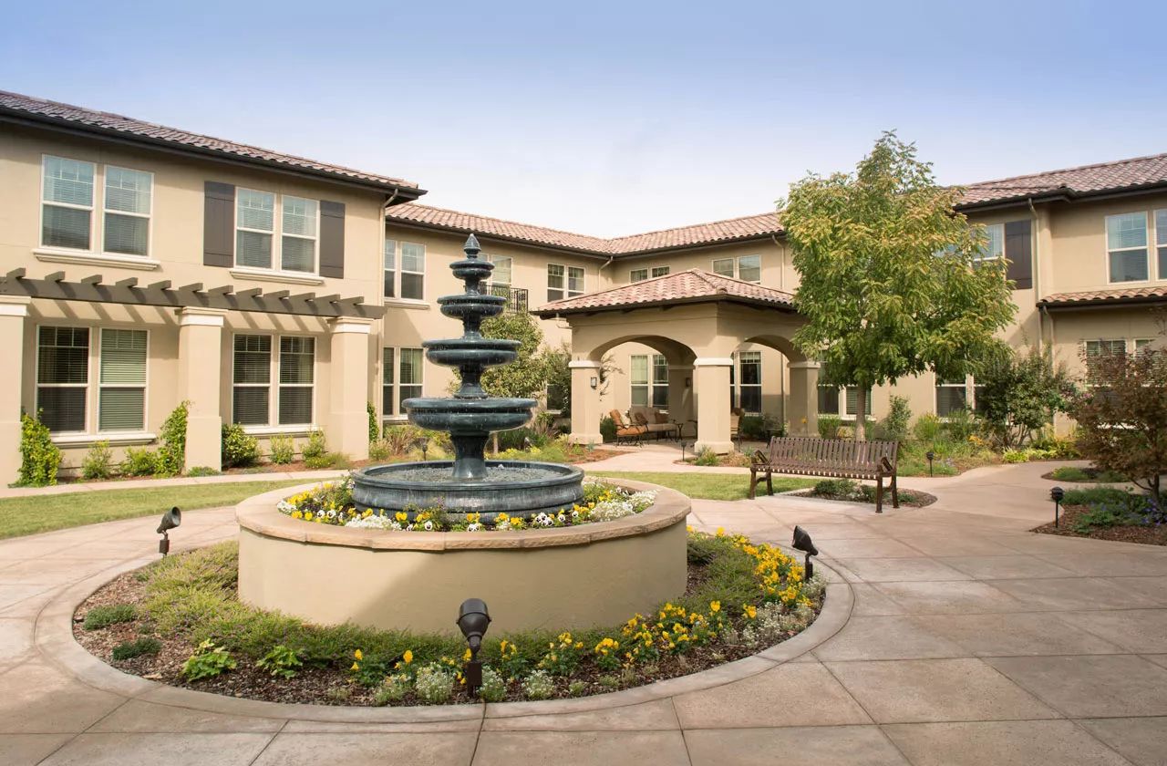 Outdoor courtyard with fountain and landscaping