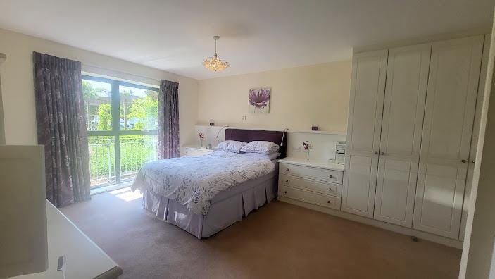 Bright and cozy resident bedroom with a view