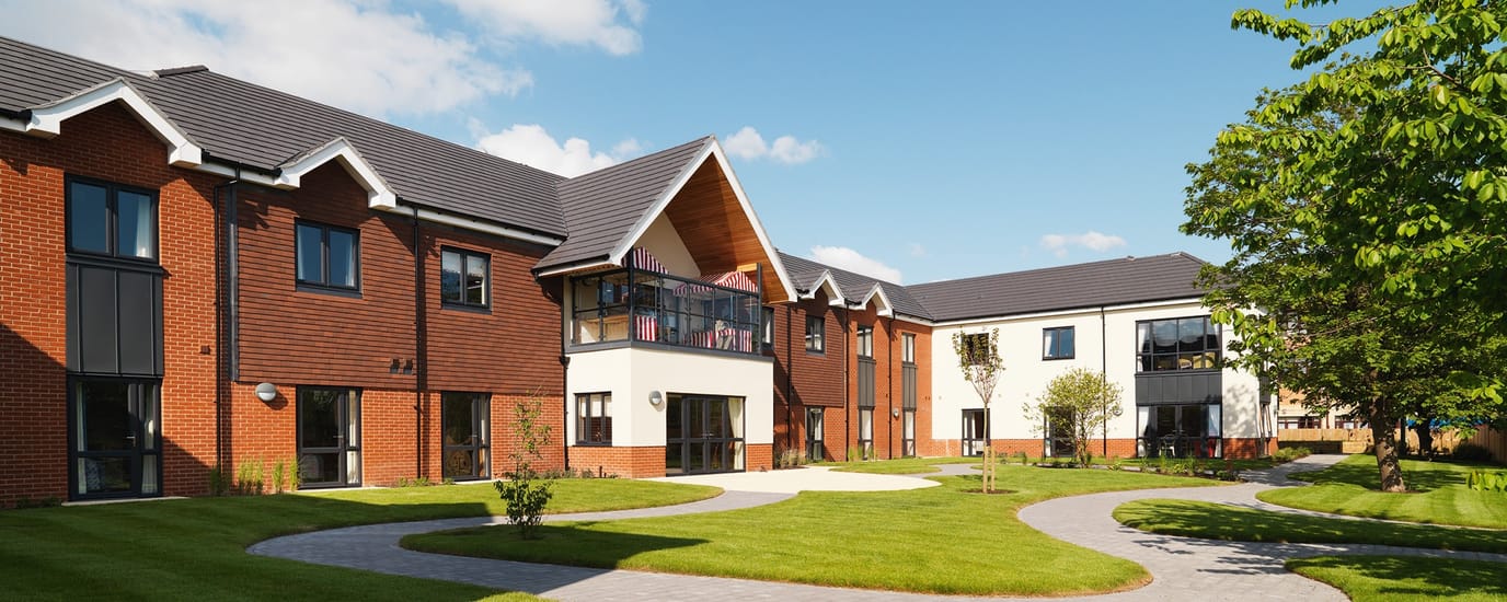 Exterior view of Hartford Court Residential Care Home with landscaped paths