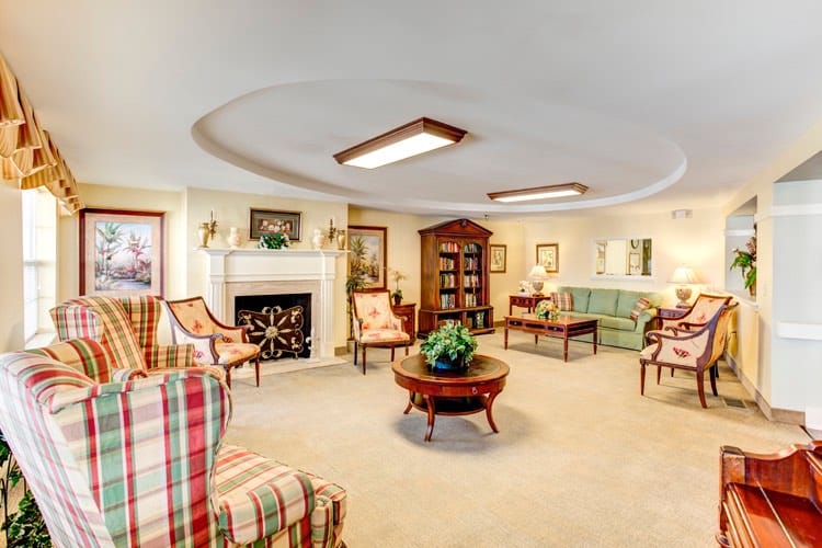 A cozy common area with comfortable seating and a fireplace