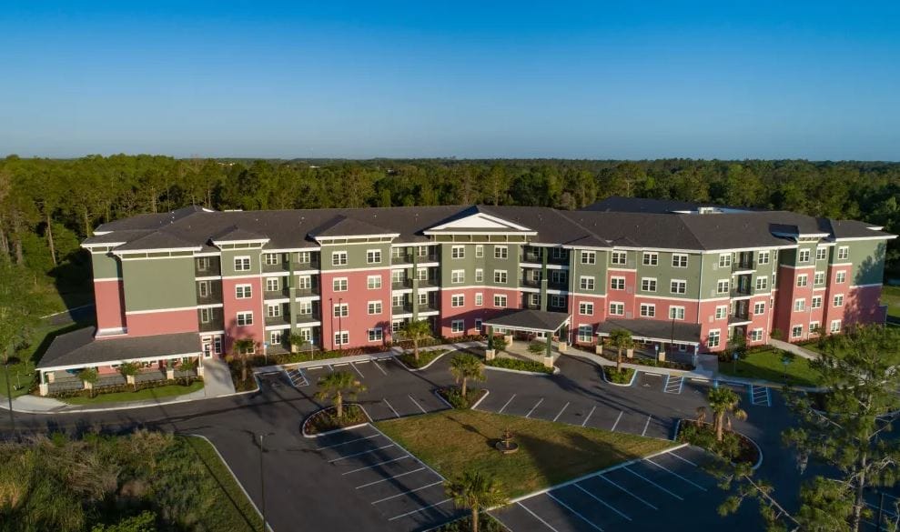 Aerial view of the assisted living facility with landscaped grounds