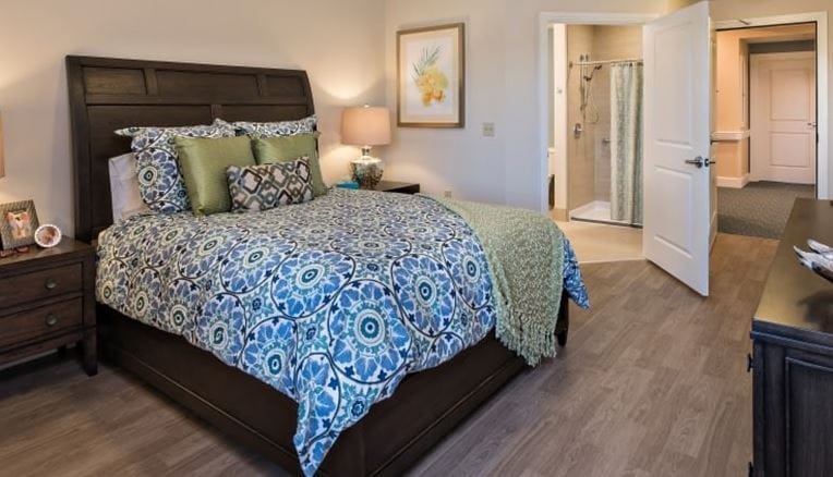 A cozy private resident room with decorative bedding
