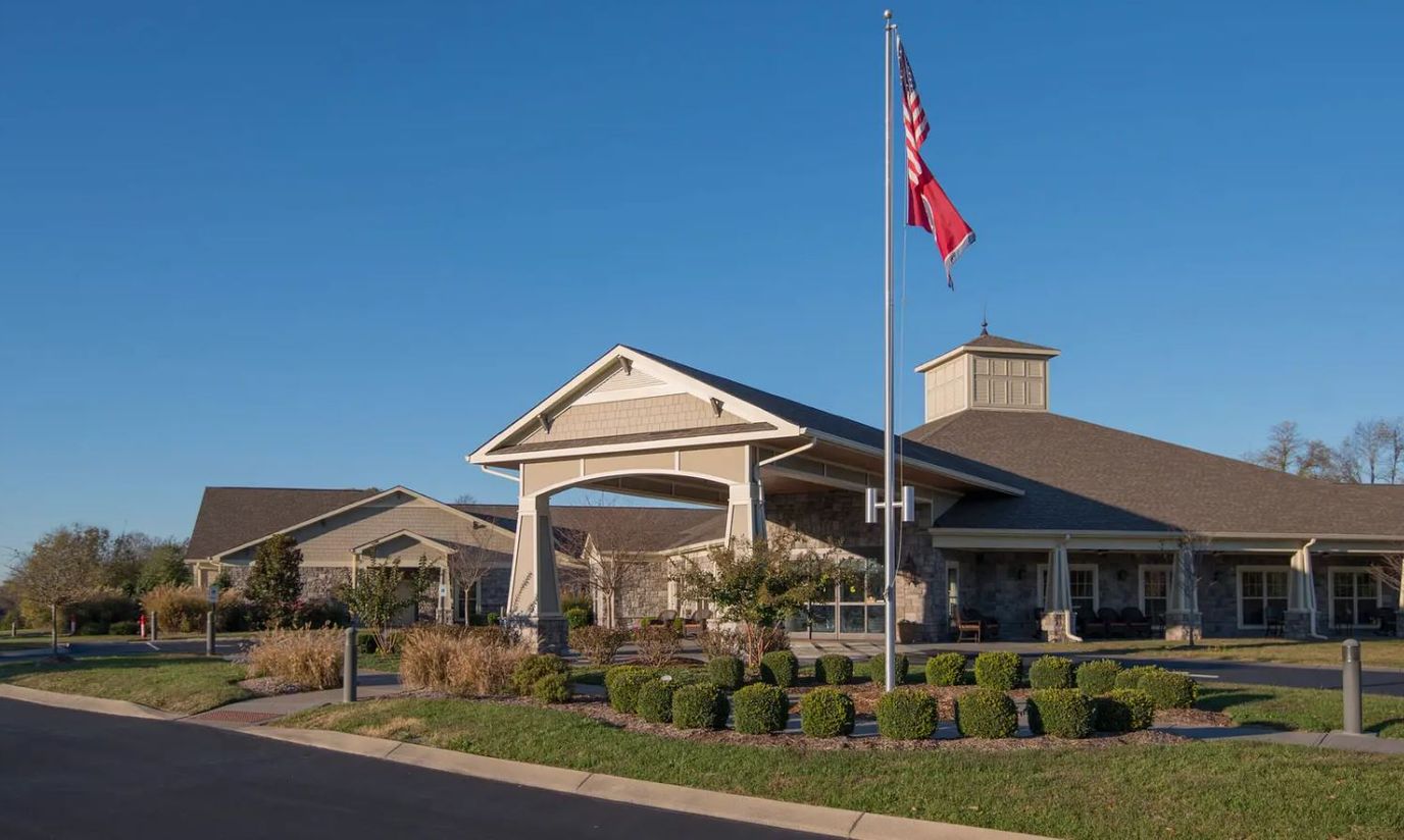 Exterior view of Morning Pointe facility with landscaped entrance