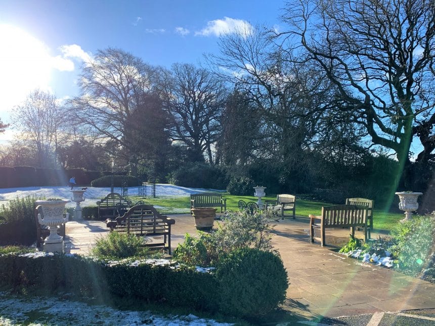 Outdoor seating area with benches and garden