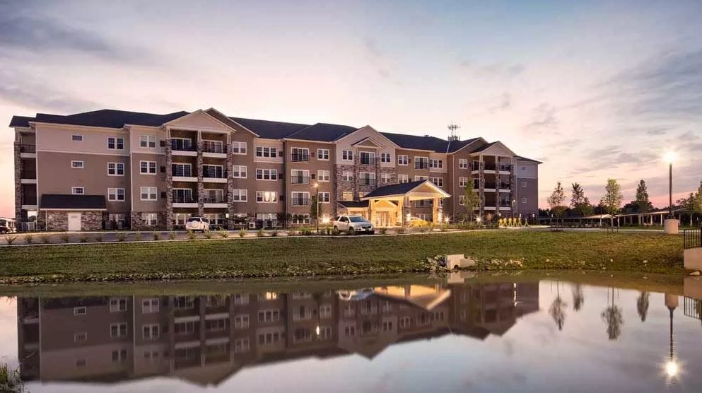 Exterior view of Oxford Villa Active Senior Apartments at dusk