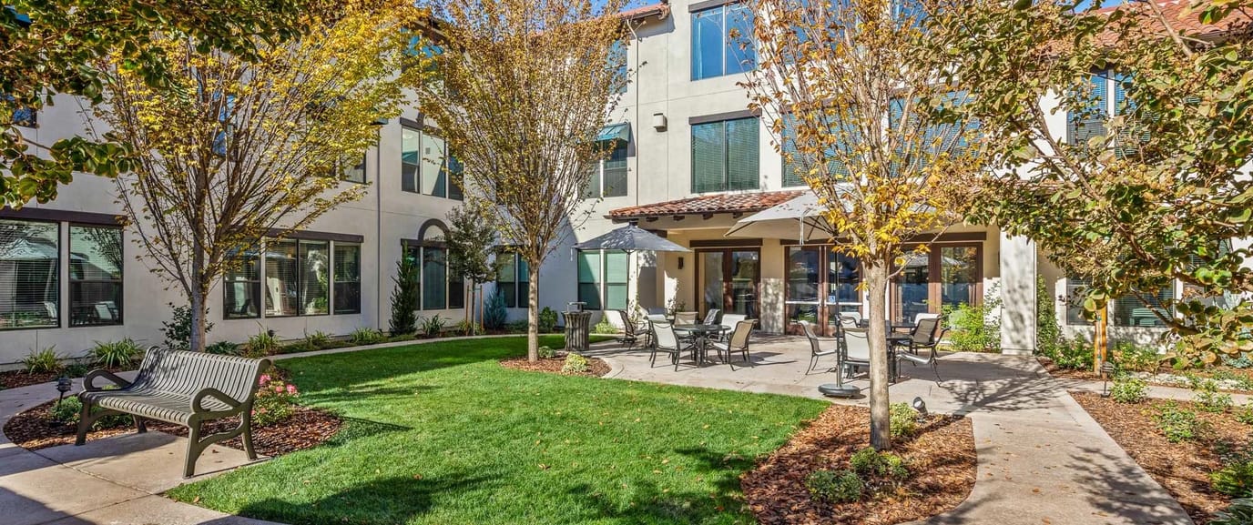 Outdoor patio area with seating and trees