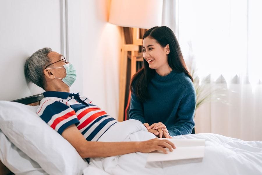 A caregiver and resident interacting in a room