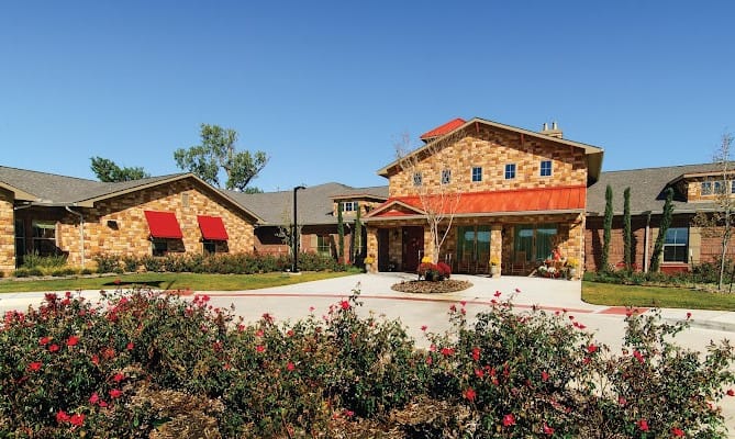 Exterior view of River Oaks facility with garden