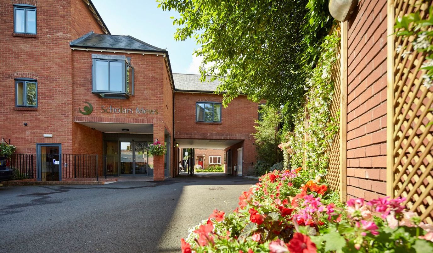 Exterior view of Scholars Mews Care Home with flowers