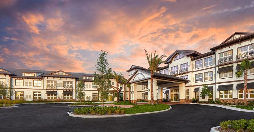 Exterior view of a senior living facility at sunset
