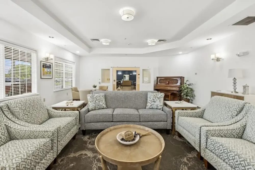 Bright common area with seating and a piano