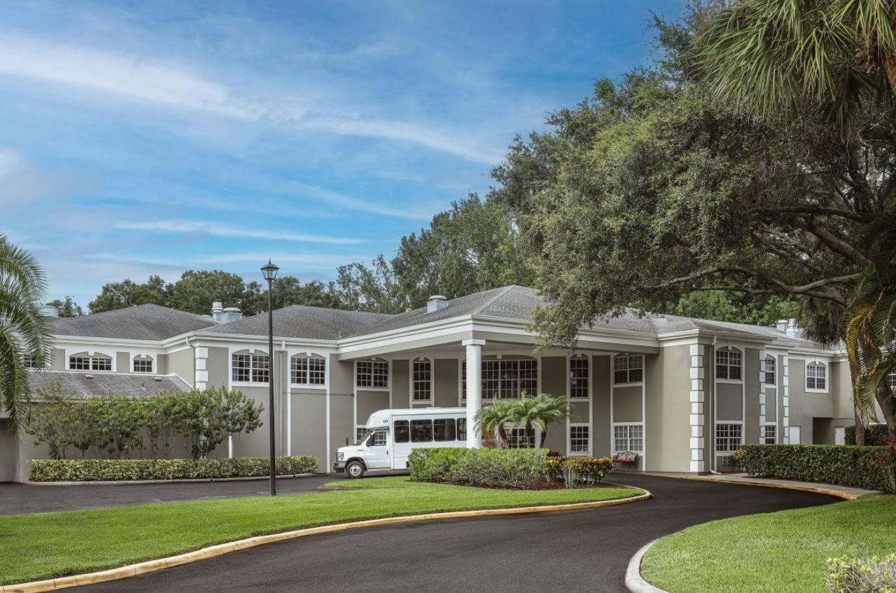 Exterior view of The Gables of Palm Harbor with facility van