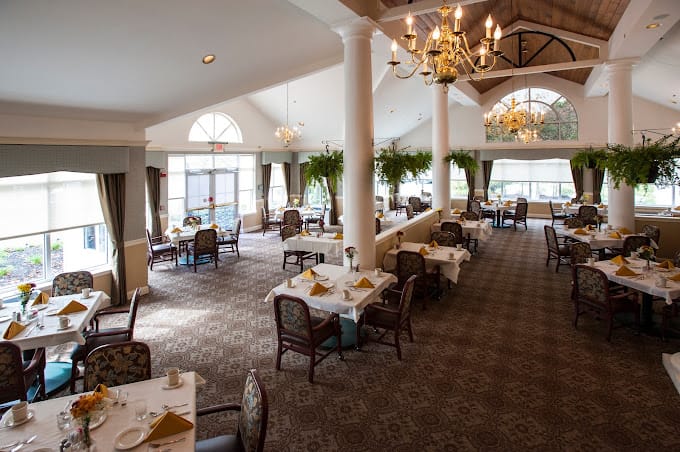 Bright dining room with tables set for residents