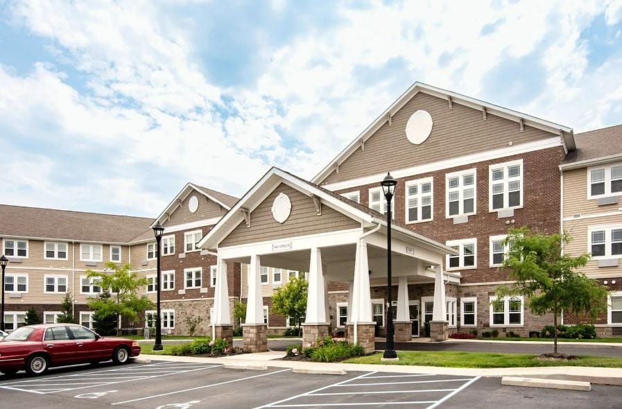 Exterior view of Woodland Terrace with landscaped parking area