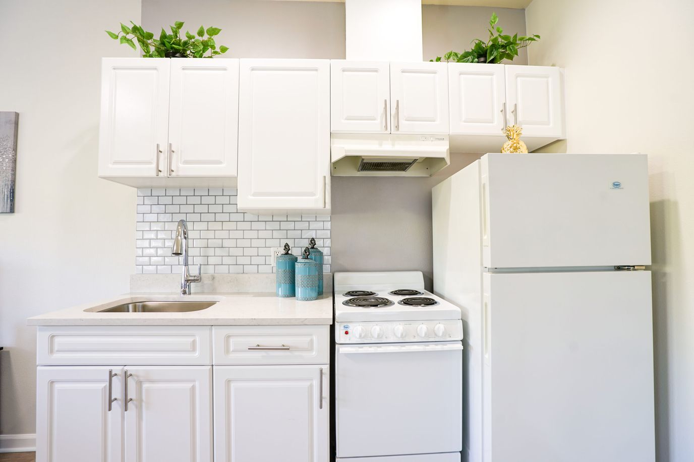 Chateau Valley Center, assisted living in Renton, WA — Compact kitchen with white cabinetry and modern appliances