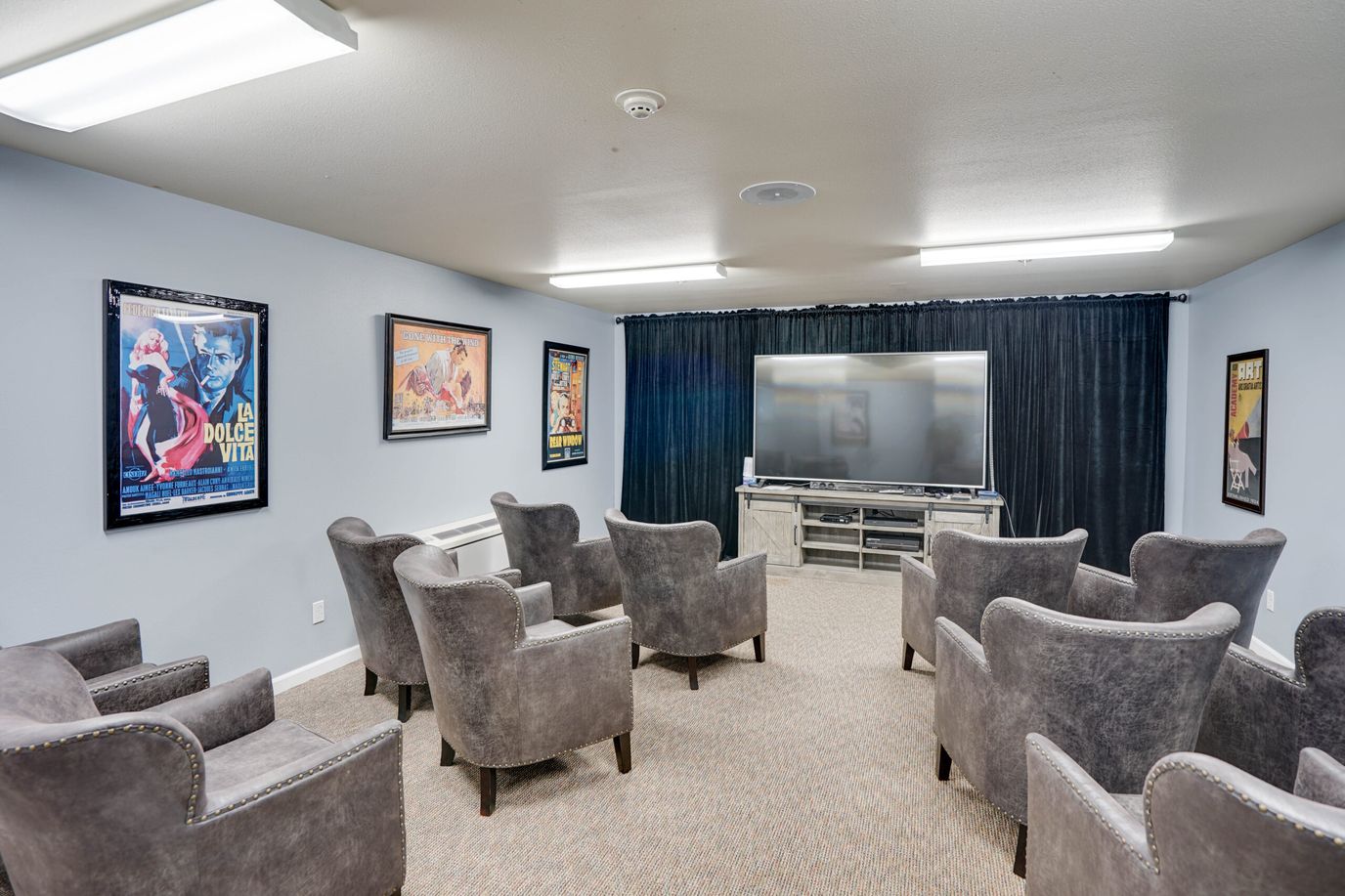 Chateau Valley Center, assisted living in Renton, WA — Cozy movie room with plush seating and classic film posters