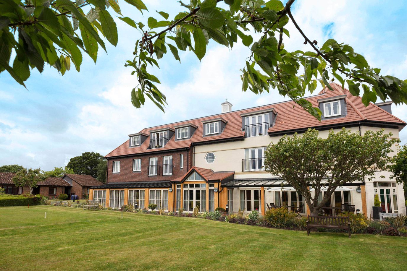 Exterior view of Elmbridge Village with gardens