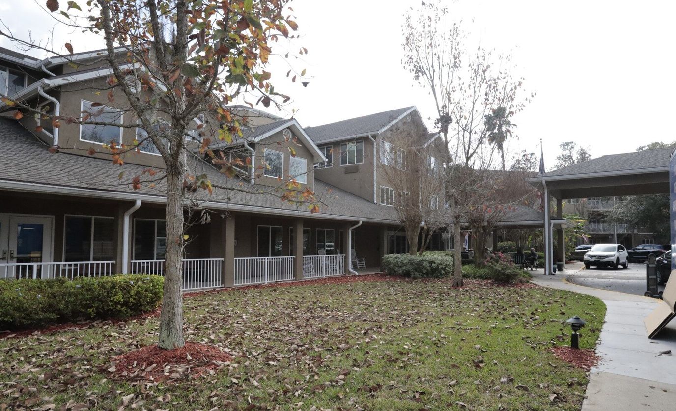 Exterior view of assisted living facility with landscaped yard