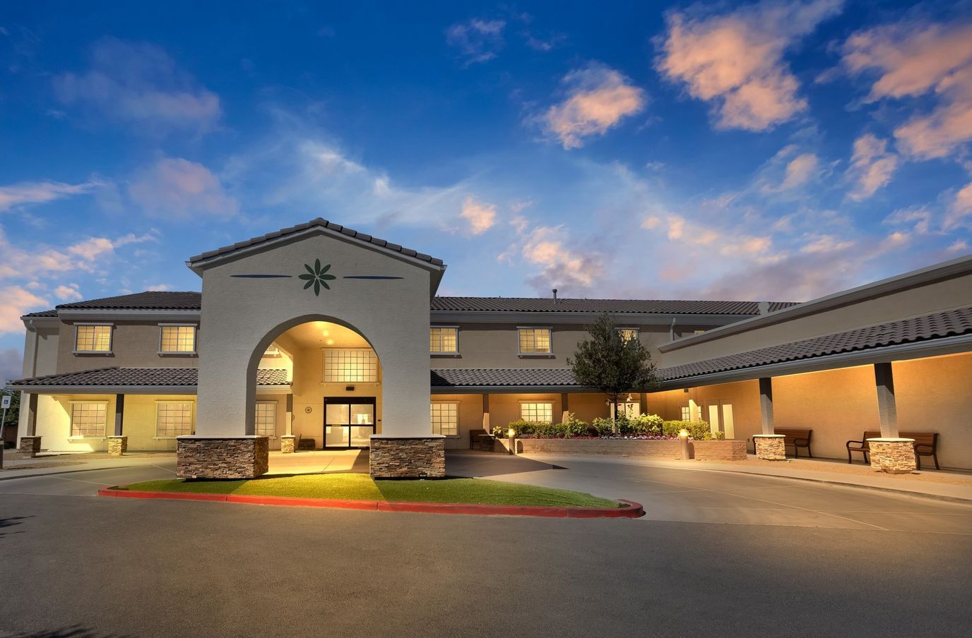 Exterior view of Inspirations Senior Living facility at dusk