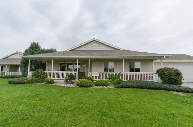 Front view of a senior living facility with garden area.