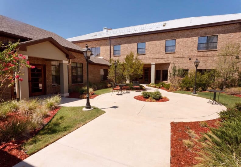 Outdoor garden area with seating in assisted living facility