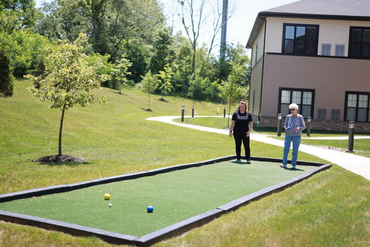 Residents enjoying outdoor bocce ball at the facility