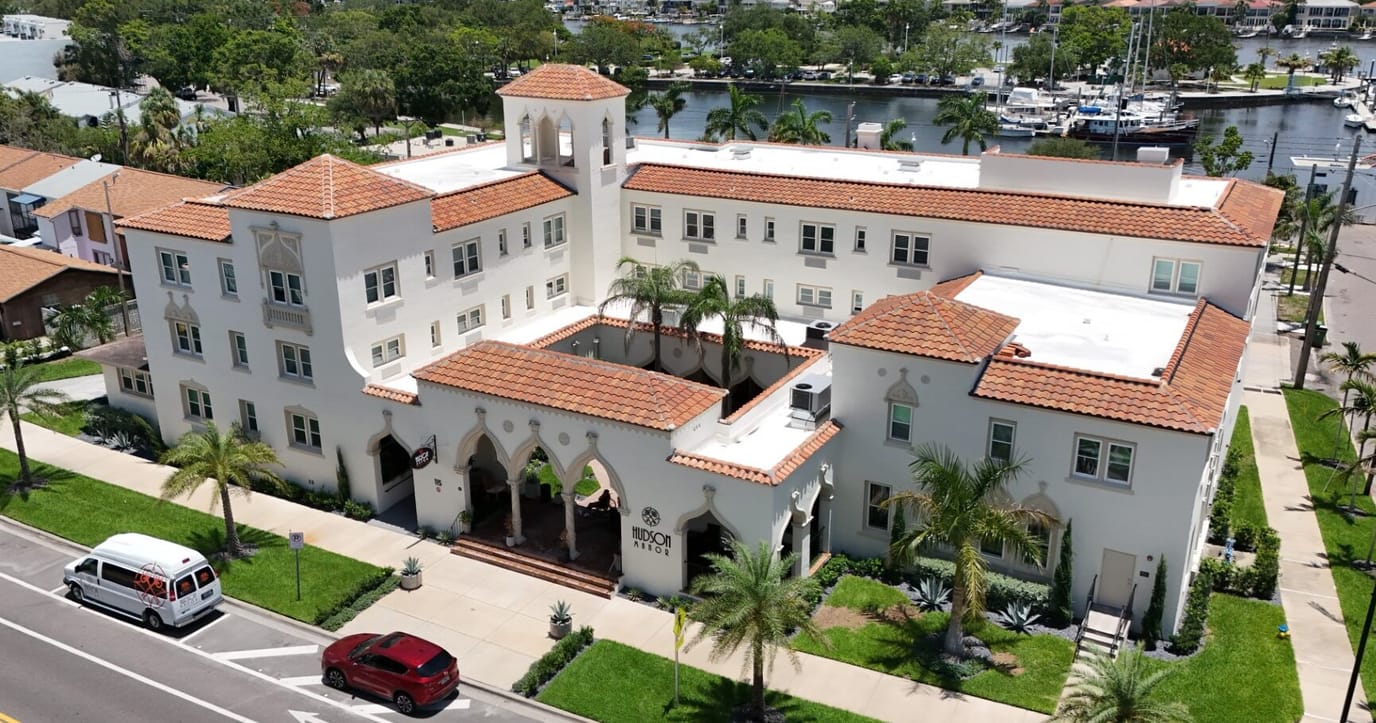 Aerial view of Hudson Manor Assisted Living with parking and outdoor space