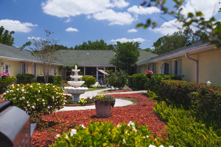 Outdoor courtyard with a fountain and flowers