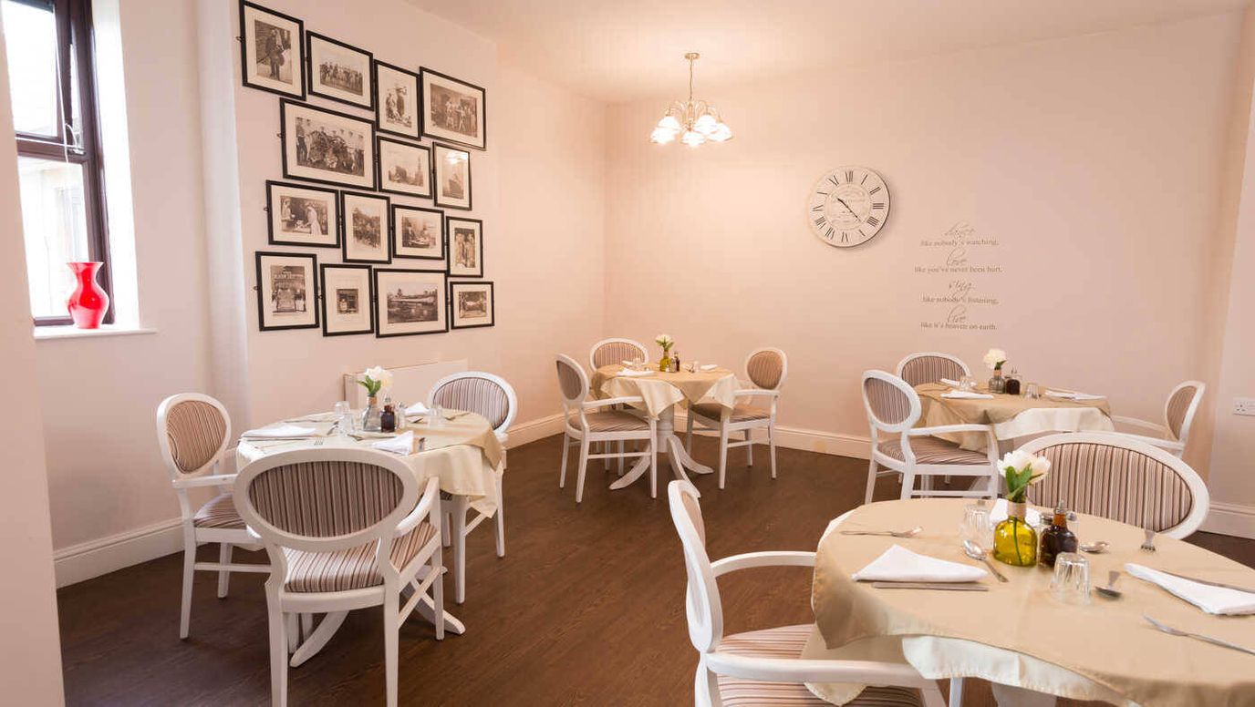 Bright dining area with tables set for meals.