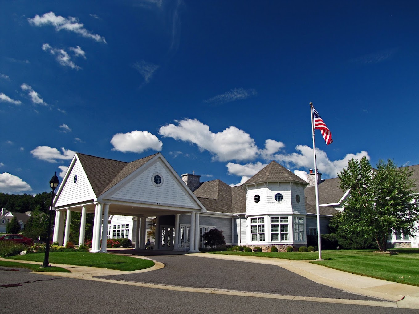 Exterior view of Cook Valley Estates with flag and landscaping
