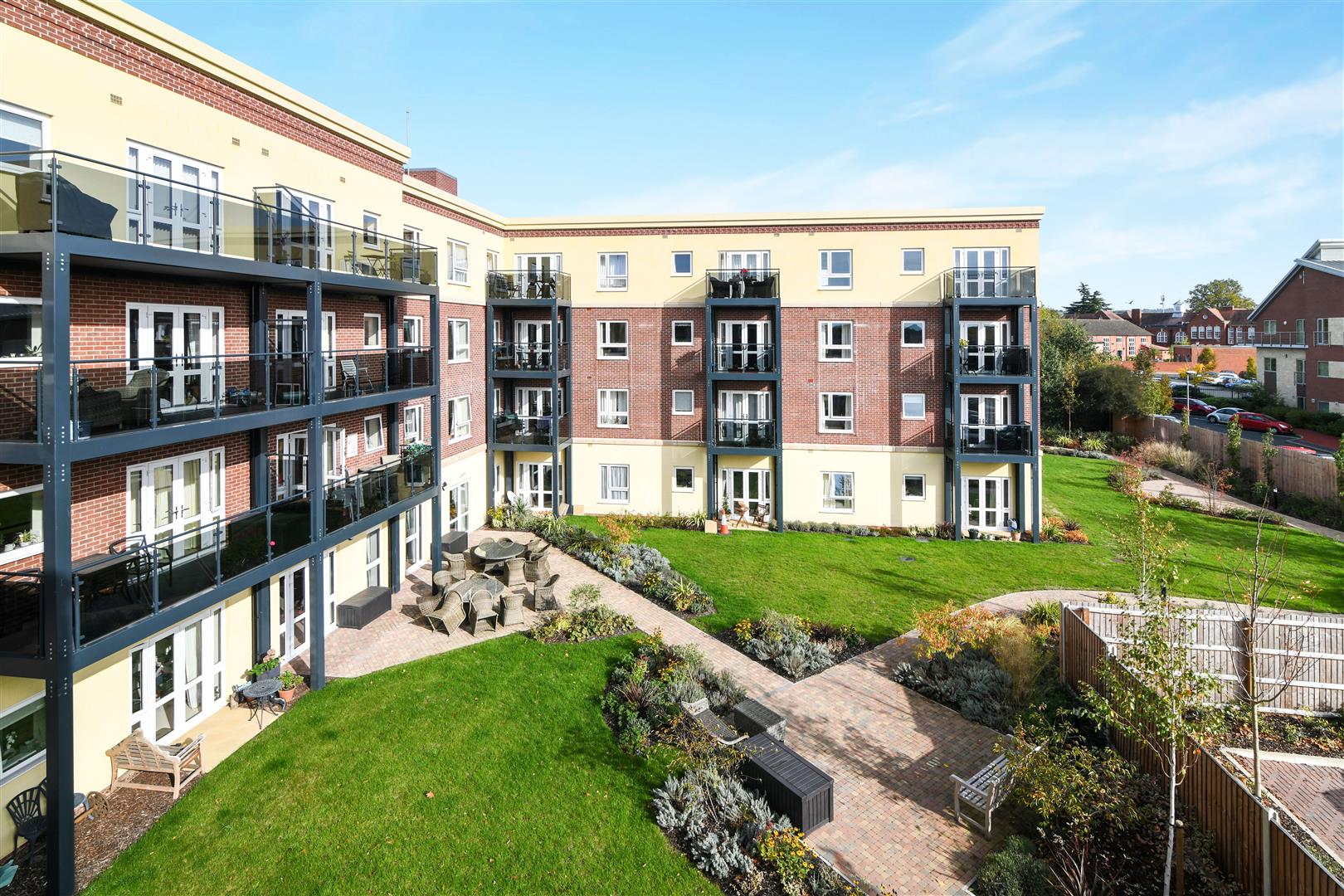 Exterior view of facility with garden and seating area.
