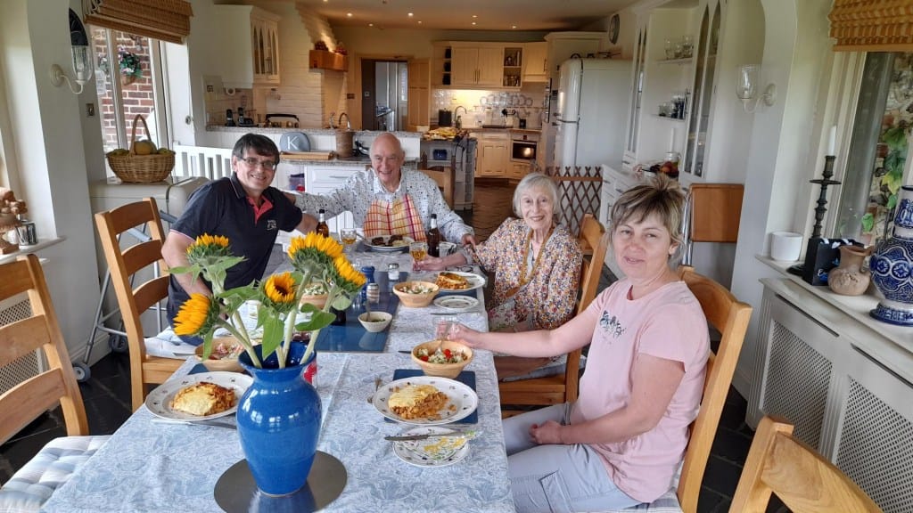 Residents and staff enjoying a meal together.