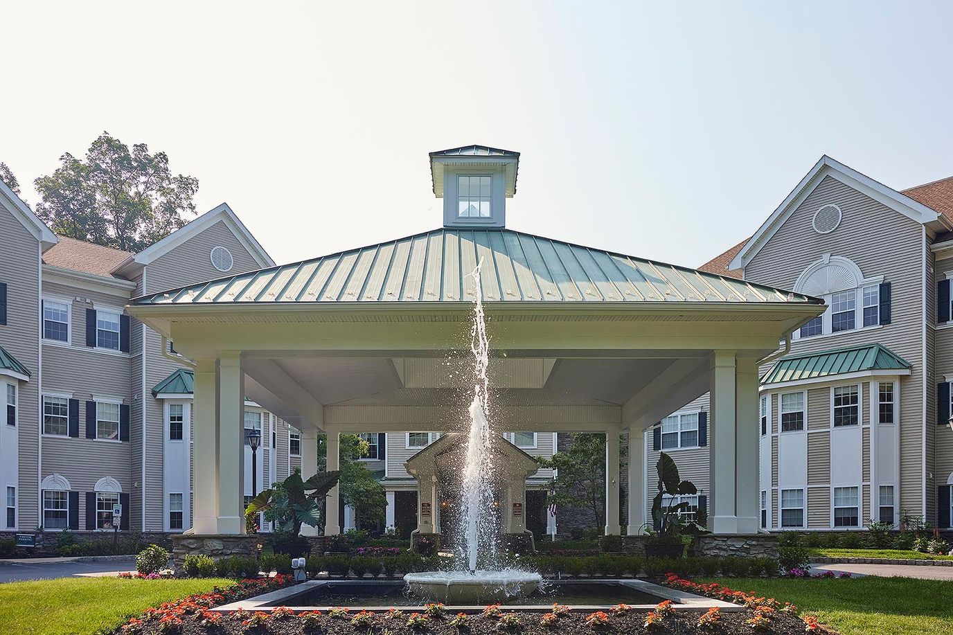 Front entrance with a fountain and landscaping.