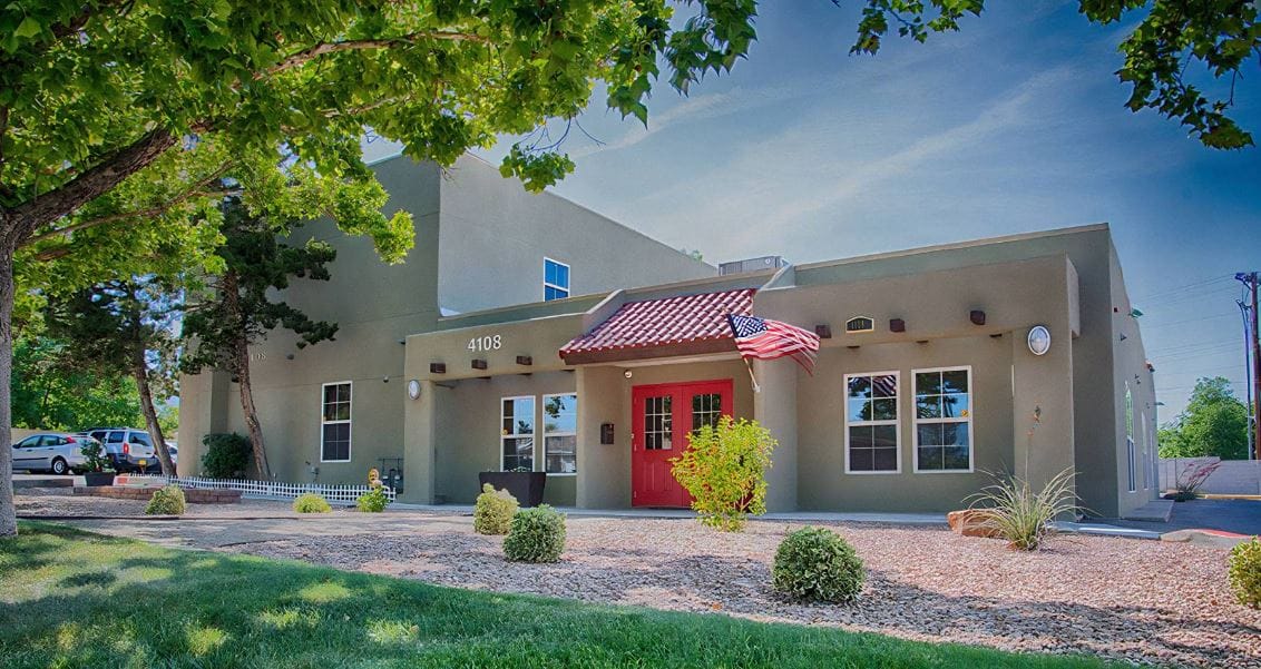 Exterior view of a senior living facility with a landscaped entrance
