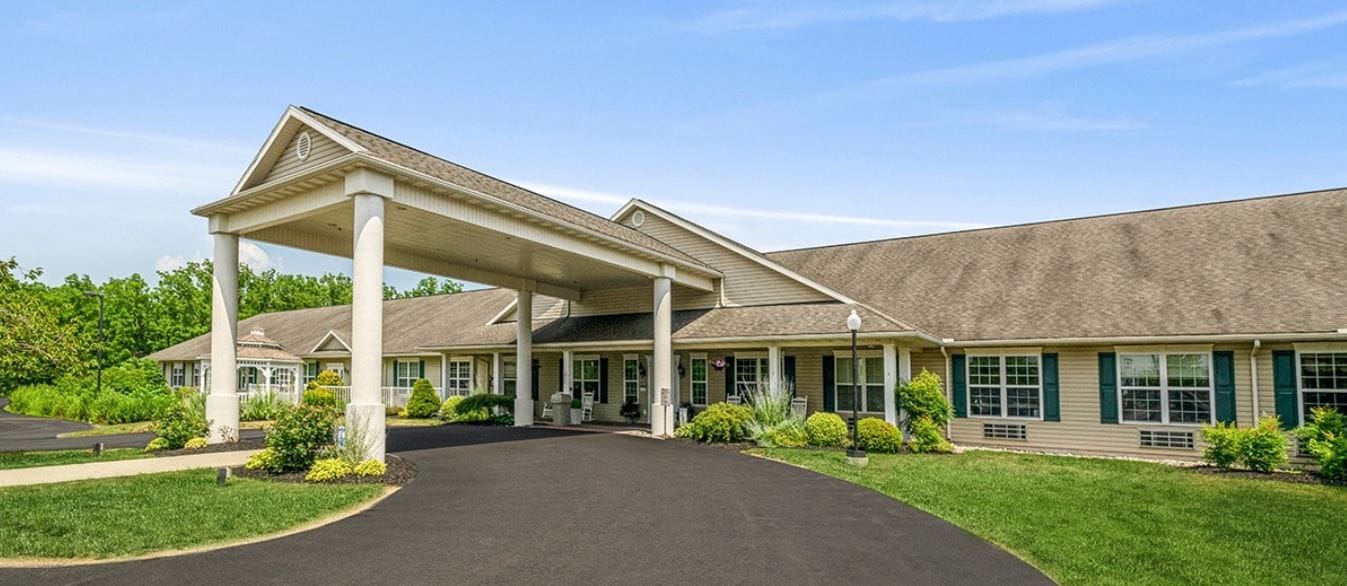Front entrance of a senior living facility with a porch