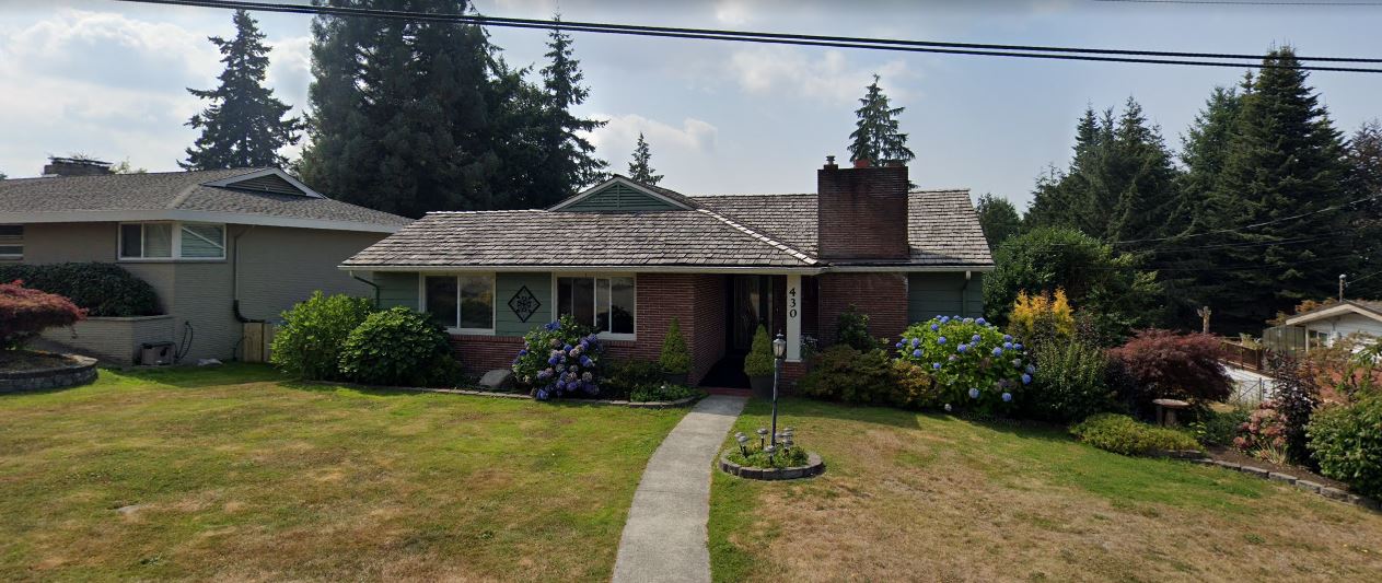 Exterior view of Amy's Adult Care Home with garden and lawn