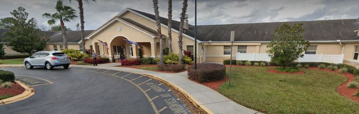 Exterior view of Arden Courts facility with landscaped garden