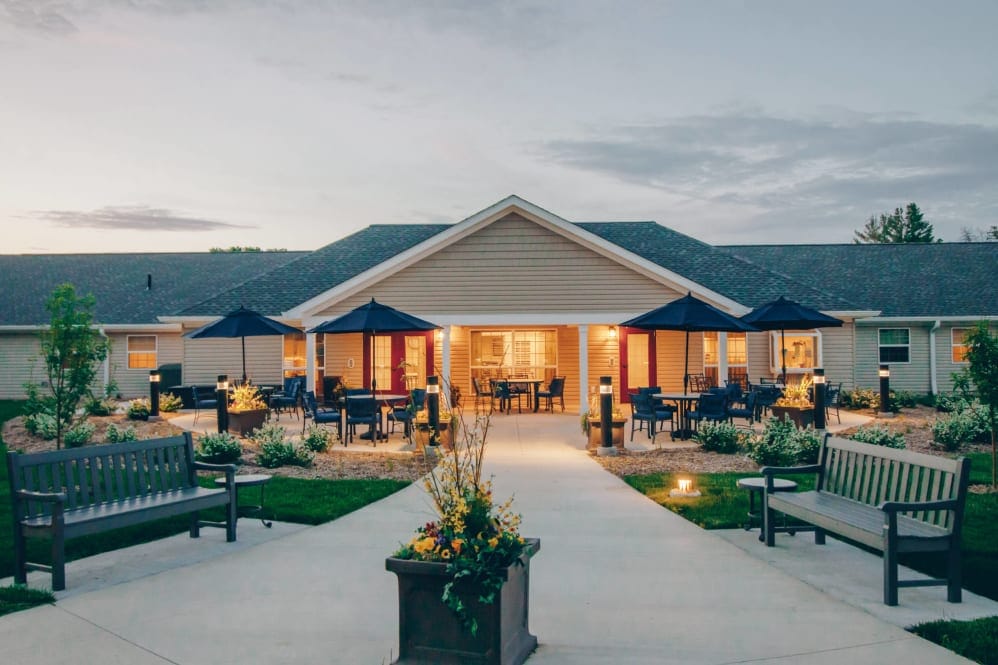Exterior view of the senior living facility with outdoor seating