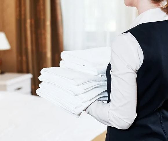 Staff member carrying freshly laundered towels