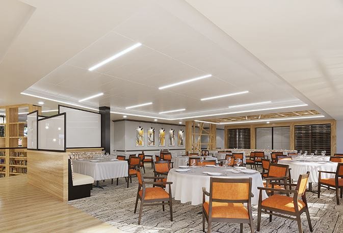Bright dining room with round tables and orange chairs