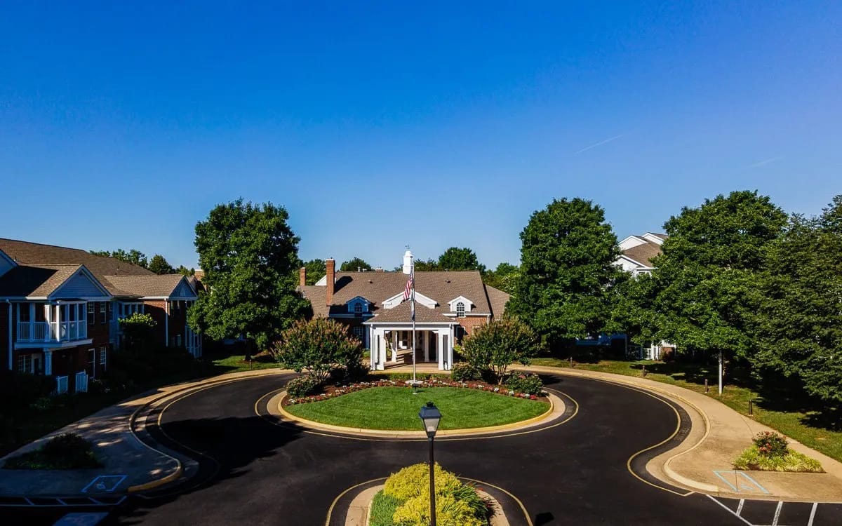 Aerial view of a senior living facility entrance and gardens