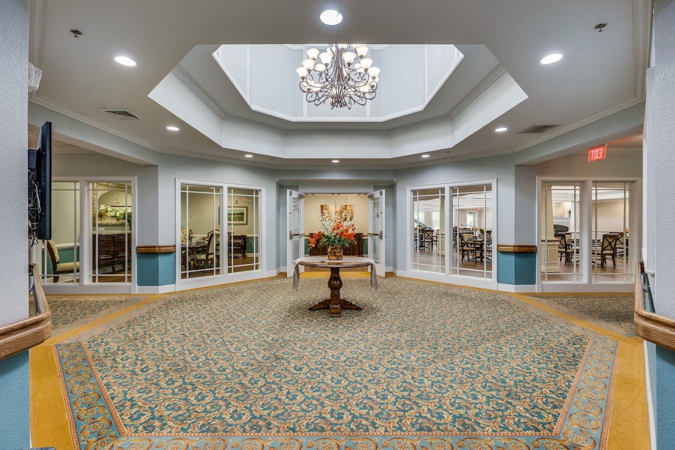 Interior view of a common area with a chandelier and seating
