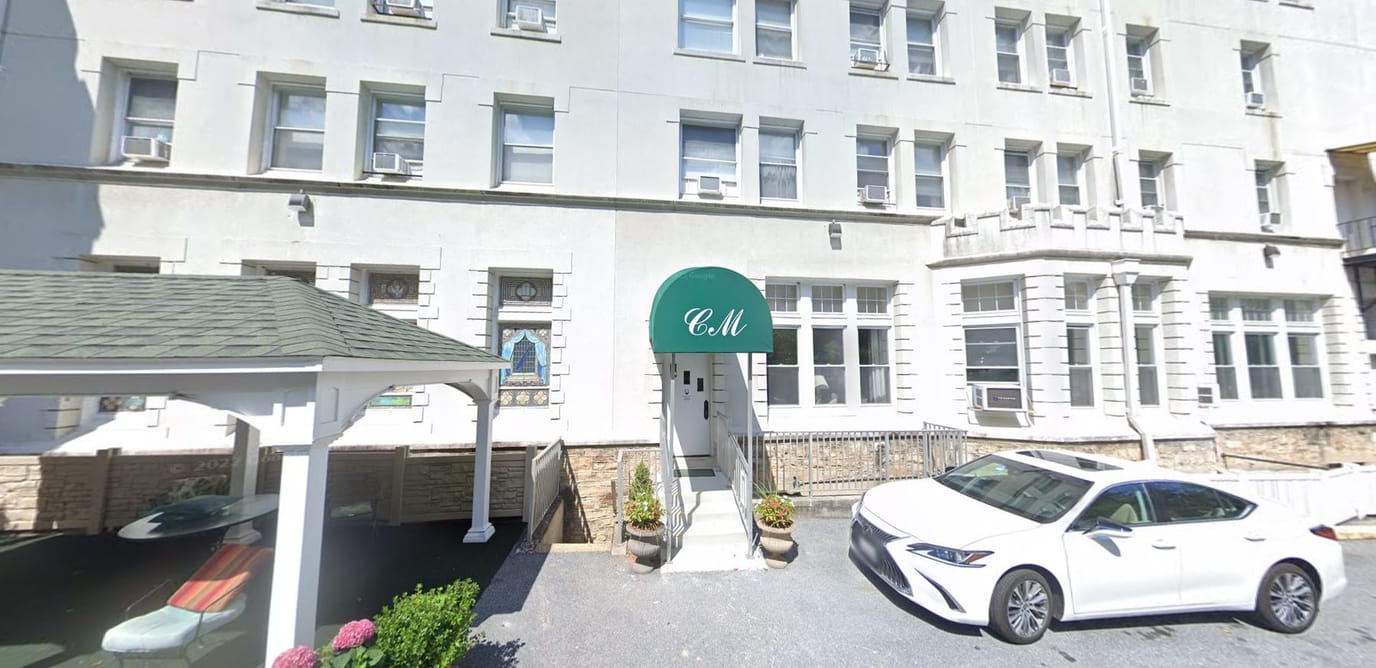 Exterior view of College Manor with entrance awning